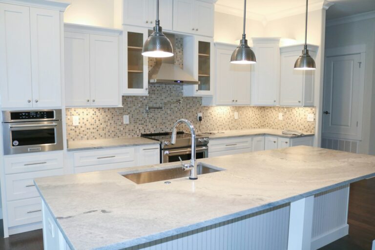 warm kitchen lighting - stainless steel faucet turned off