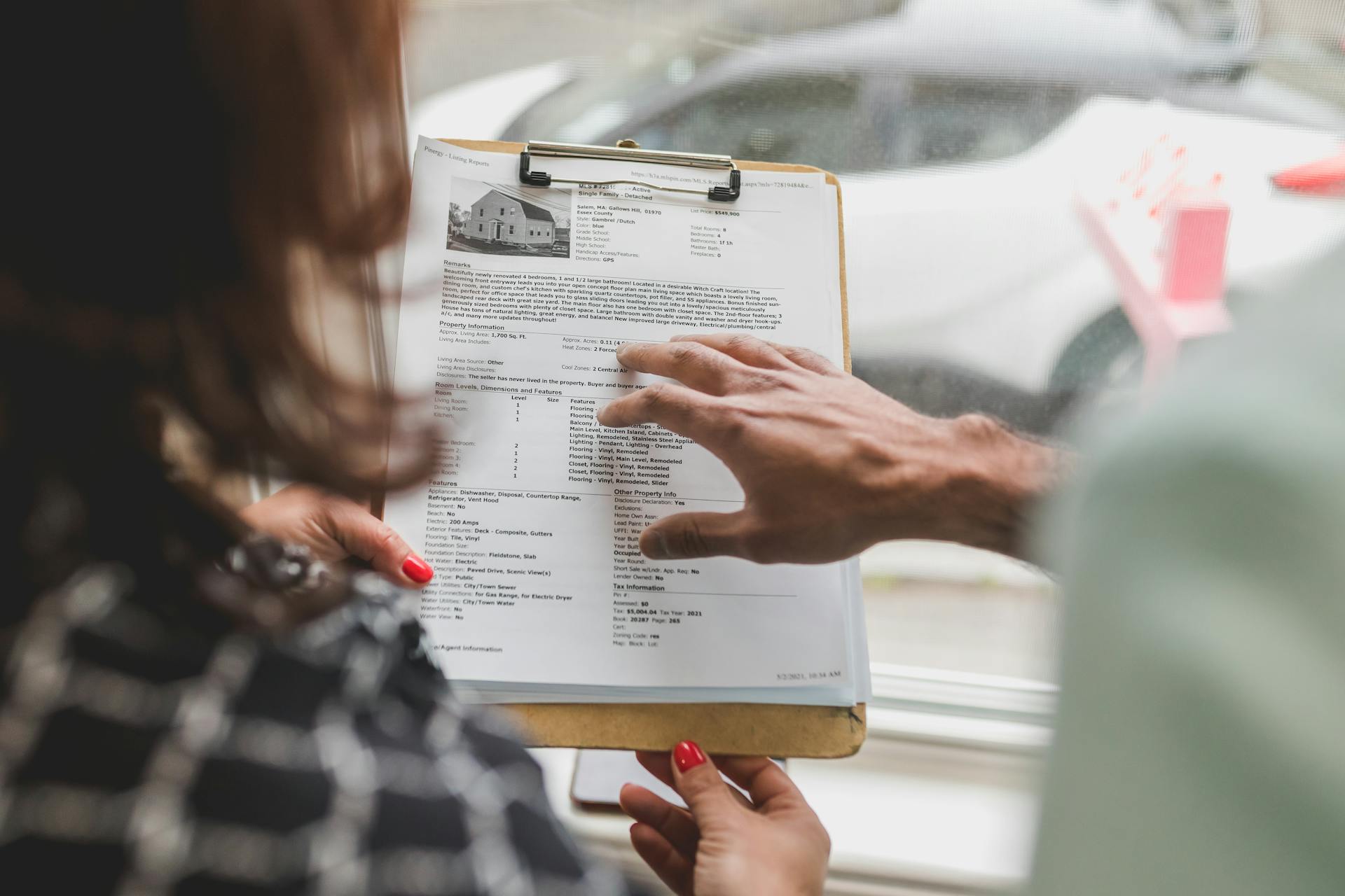interior designer client meeting holding a proposal document