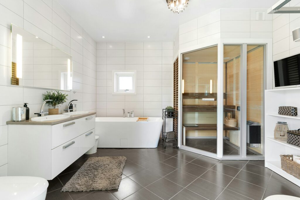 A bathroom with a tub, sink, mirror, and toilet