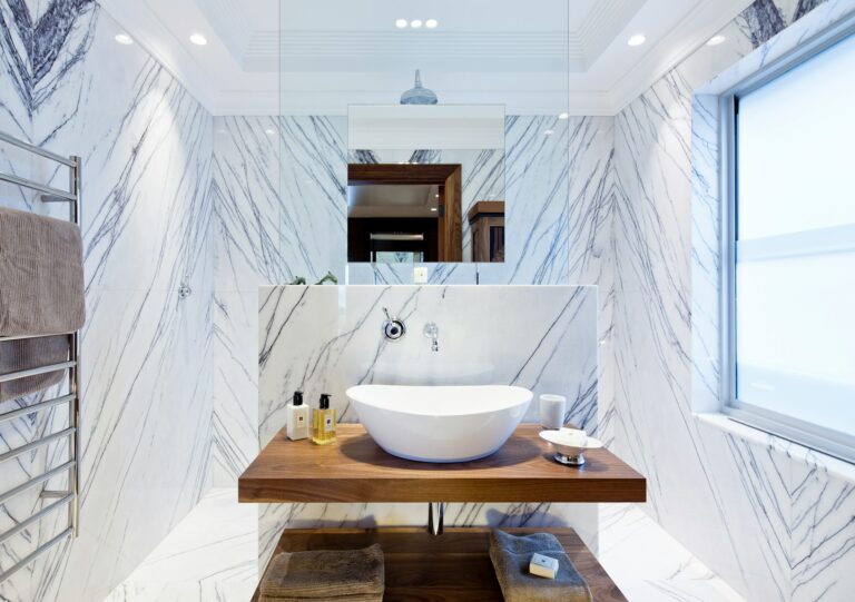 Clean white ceramic sink on brown wooden table