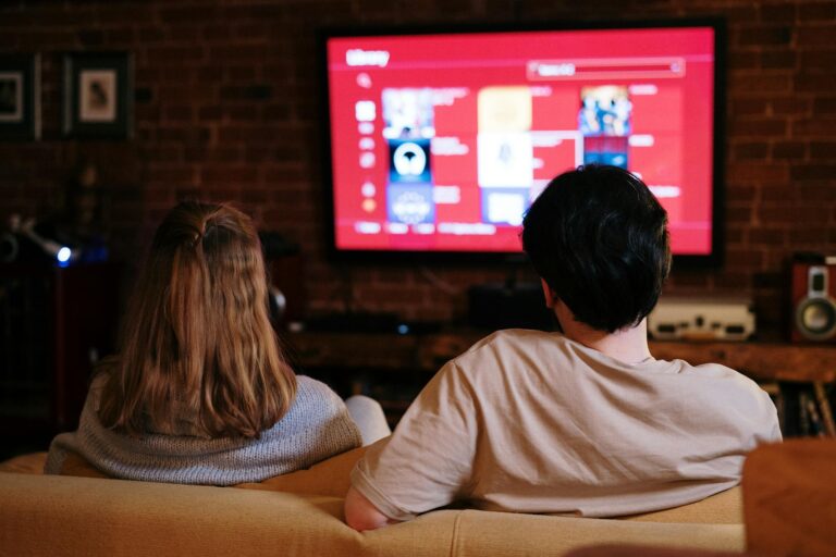 A couple watches a movie on TV