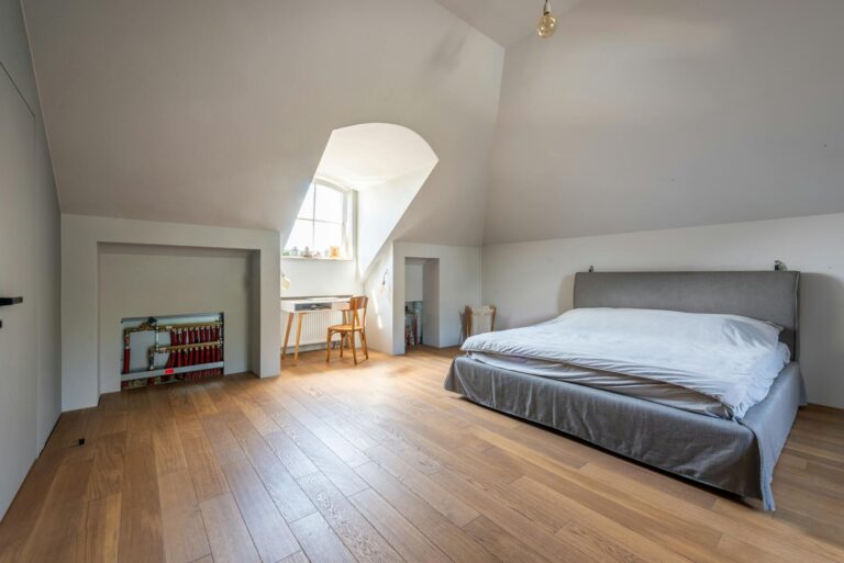 White and Gray Bed in Attic Bedroom