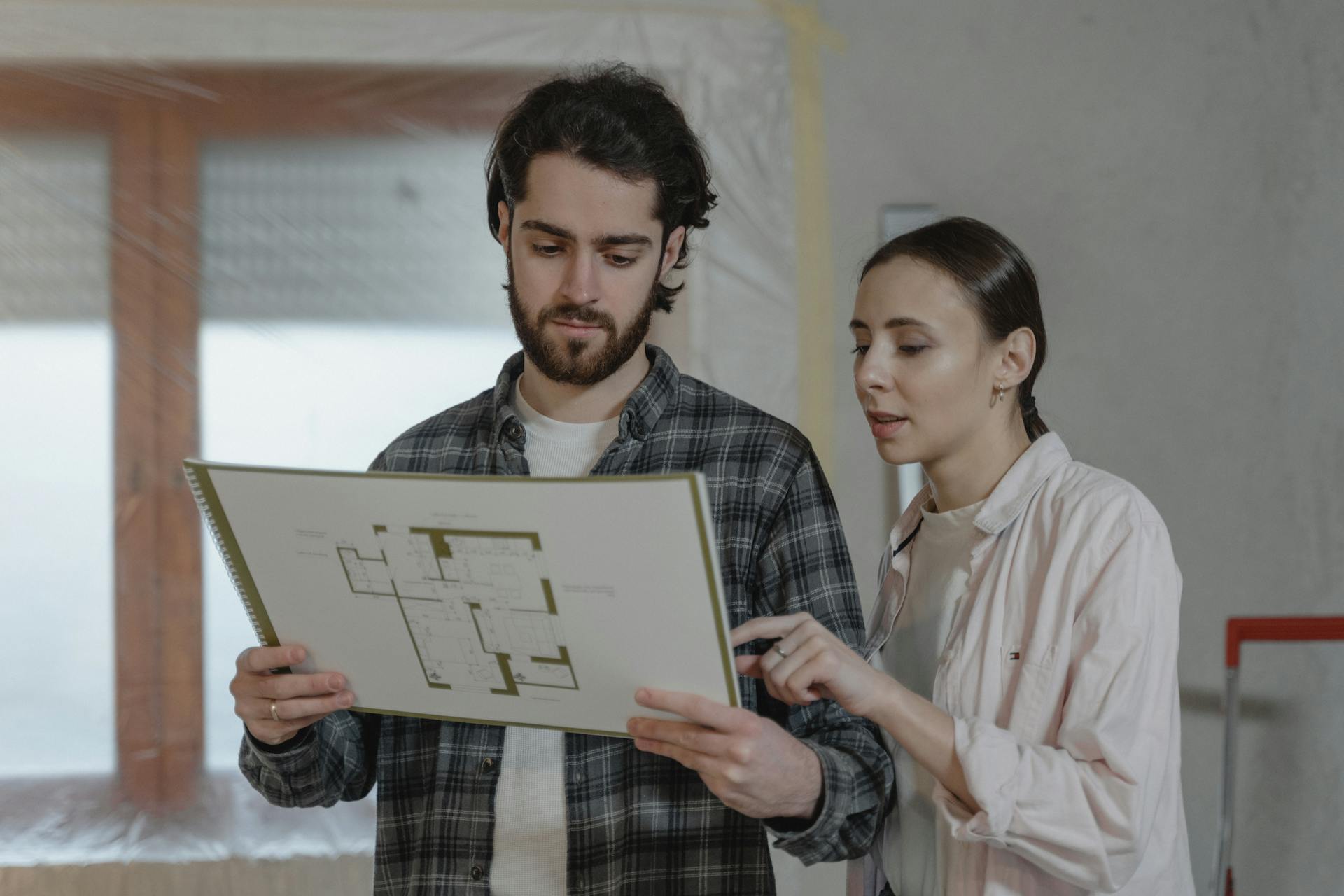 A Couple Discussing About Floor Plans