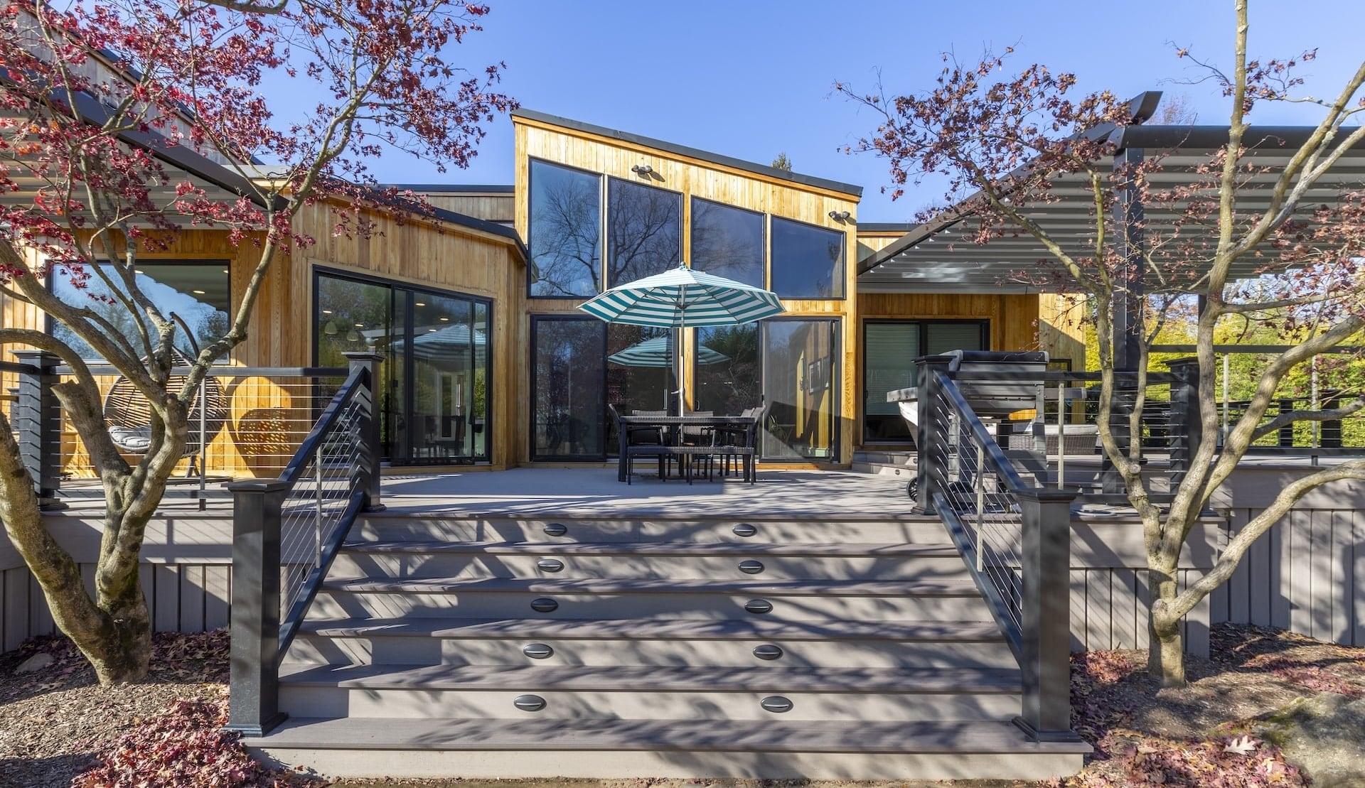 Outdoor Living Spaces Remodeling and Exterior Design in NJ. Custom Remodeling with a deck, pergola, and modern exterior design.