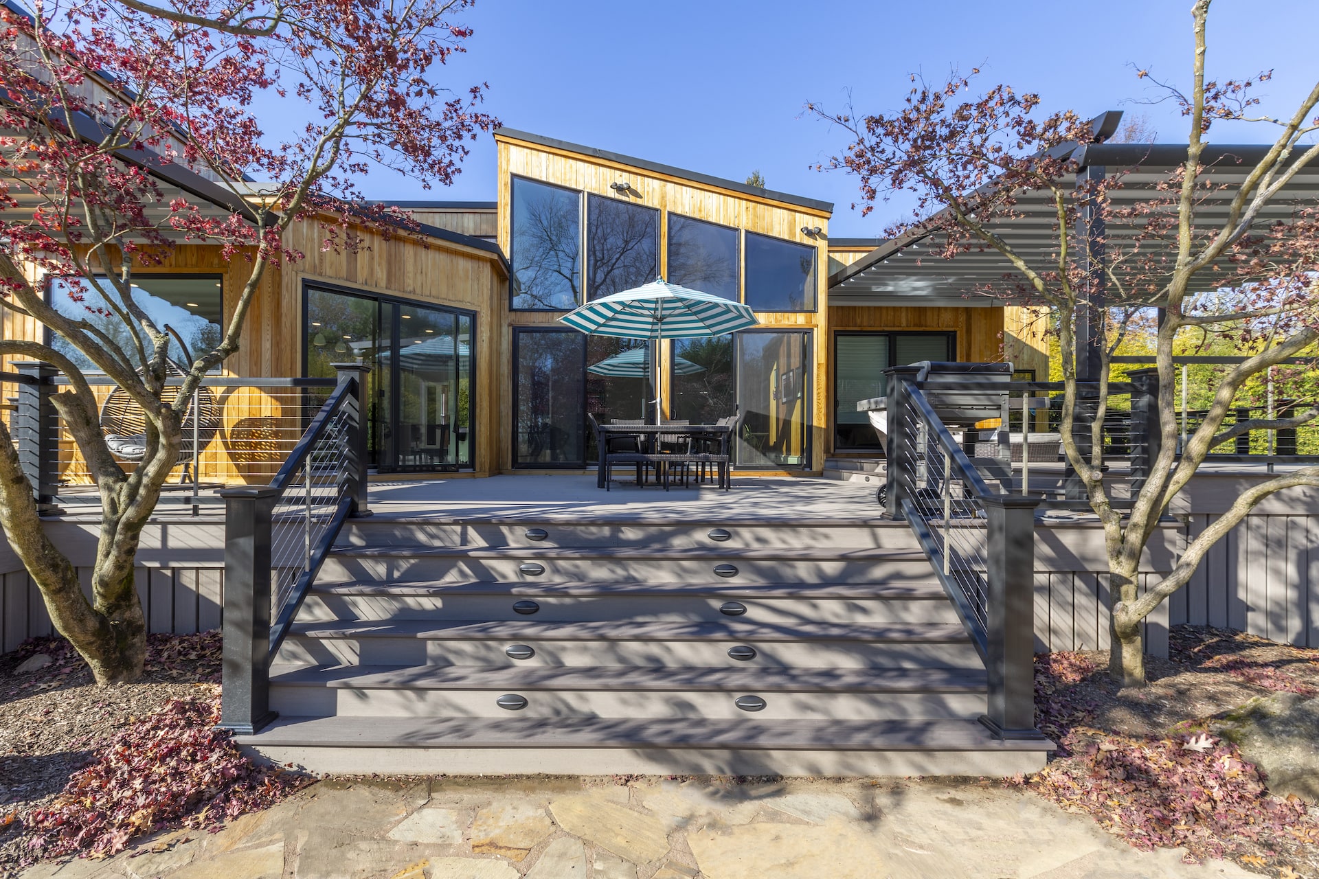 Outdoor living space with deck, pergola, and modern exterior design – New Jersey home renovation