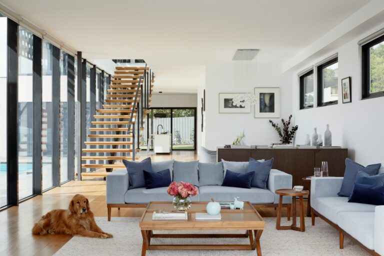 Modern open-concept living room with Scandinavian furniture, floating staircase, and natural light – Interior Renovation in New Jersey