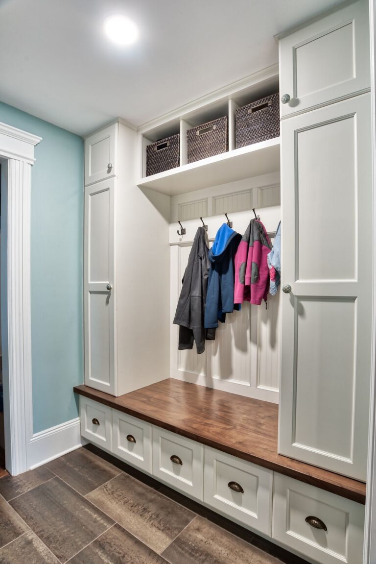 This mudroom showcases beautifully crafted cabinetry with a classic white finish.