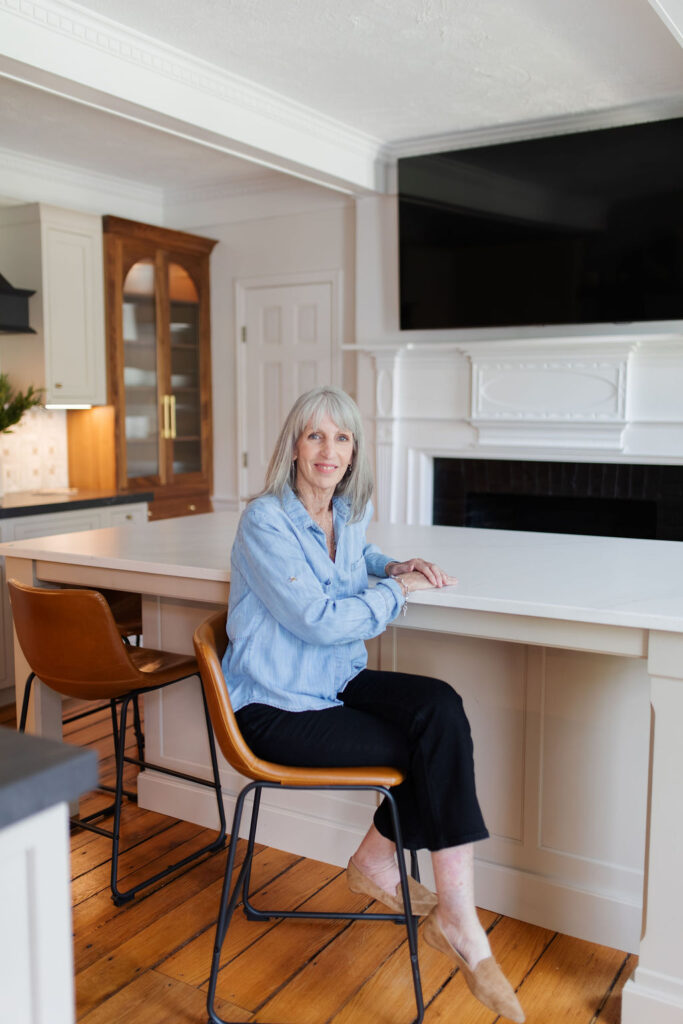 Julie Gockeler sitting on chair inside the showroom
