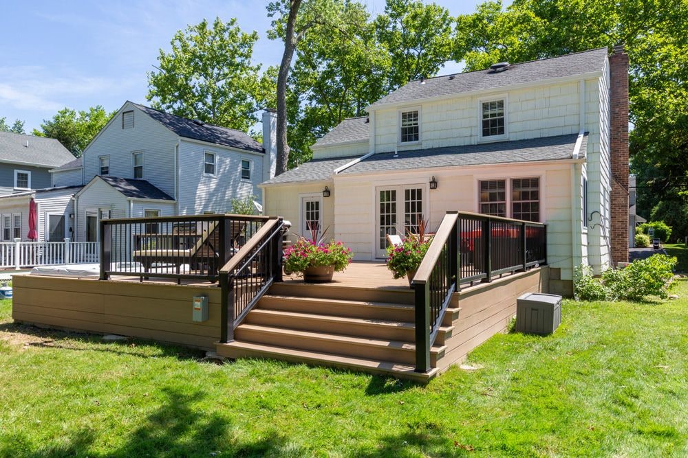 Suburban home with a newly built backyard deck, showing a thoughtful home improvement instead of relocation