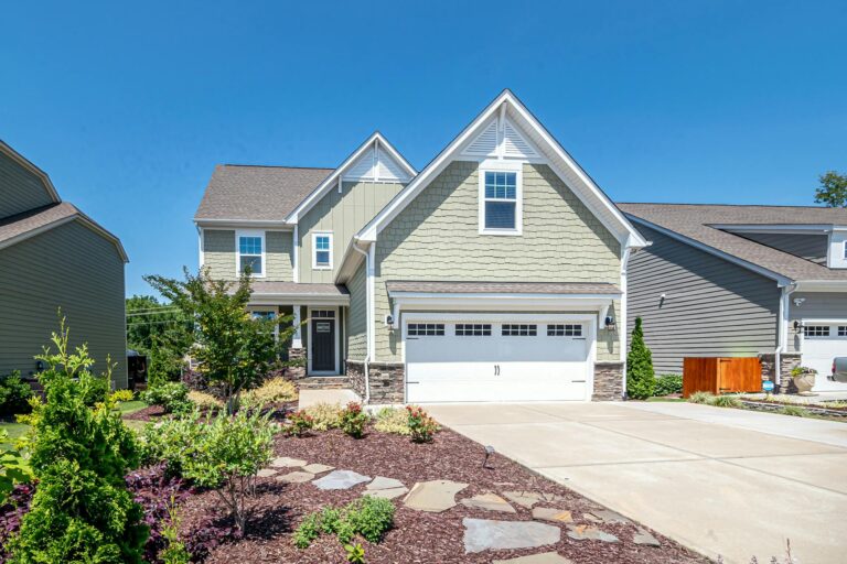 Front view of a well-maintained home addition with clean rooflines, siding, and landscaping