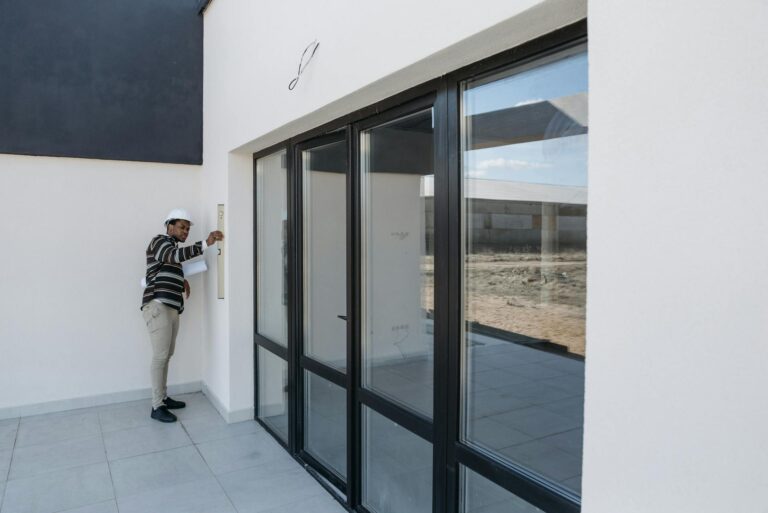 Contractor inspecting home exterior for permit compliance in New Jersey remodel project