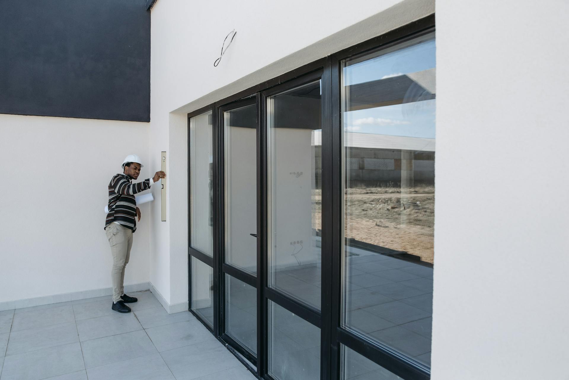 Contractor inspecting home exterior for permit compliance in New Jersey remodel project