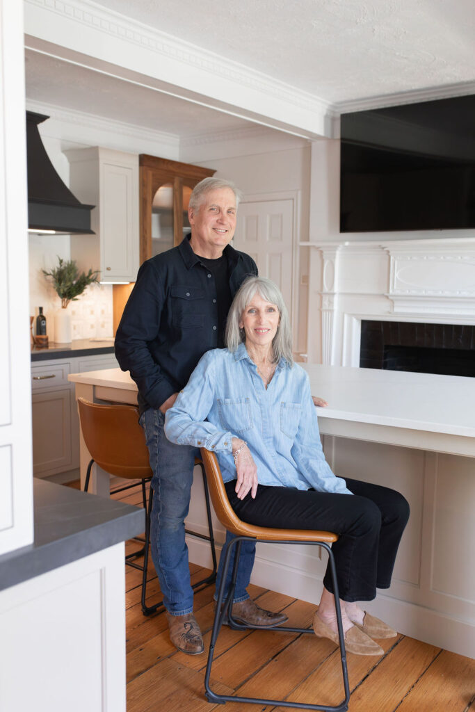 KraftMaster Renovations founders posing inside a completed luxury kitchen remodel in New Jersey