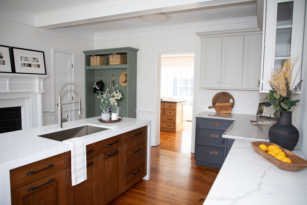 Luxury demo kitchen at the KraftMaster Renovations showroom in Chatham, NJ, featuring walnut cabinetry and quartz island