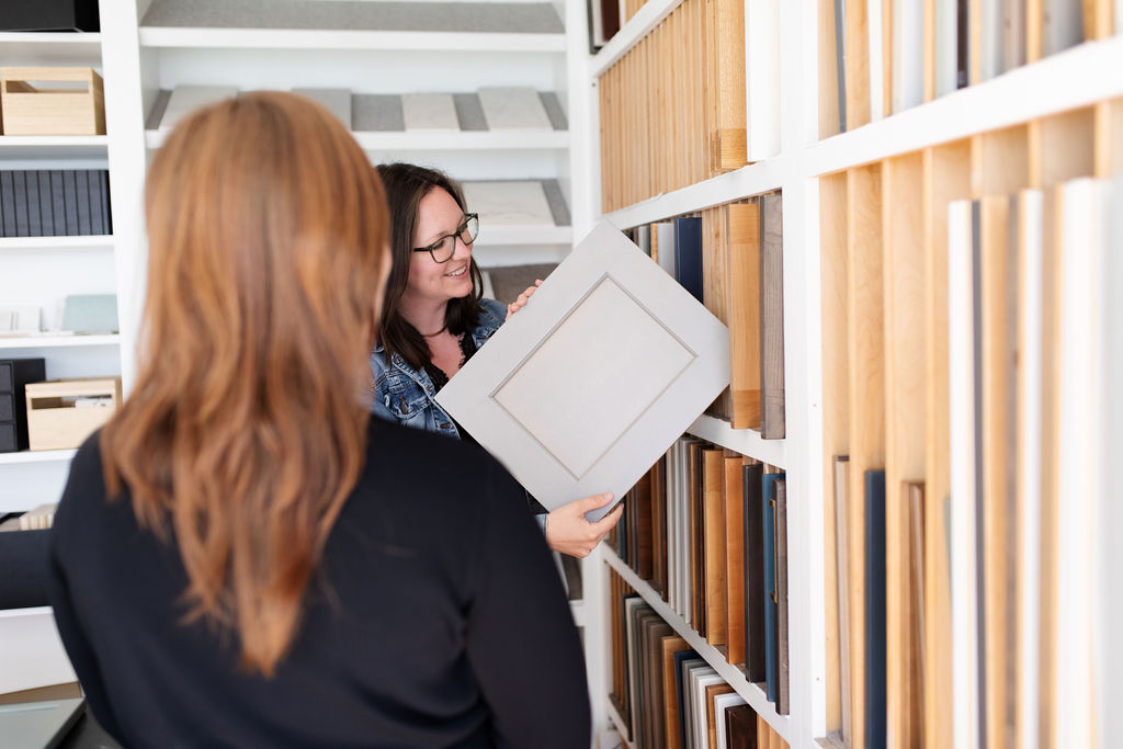 Designer presenting cabinet samples at the KraftMaster Renovations design showroom