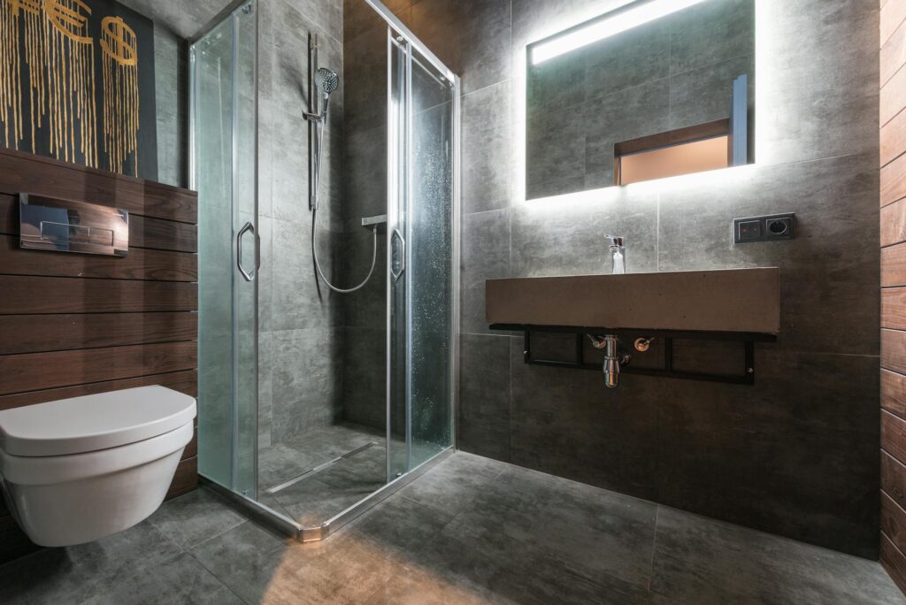 Bathroom with freestanding soaking tub, stone wall, and natural wood tones for a warm atmosphere