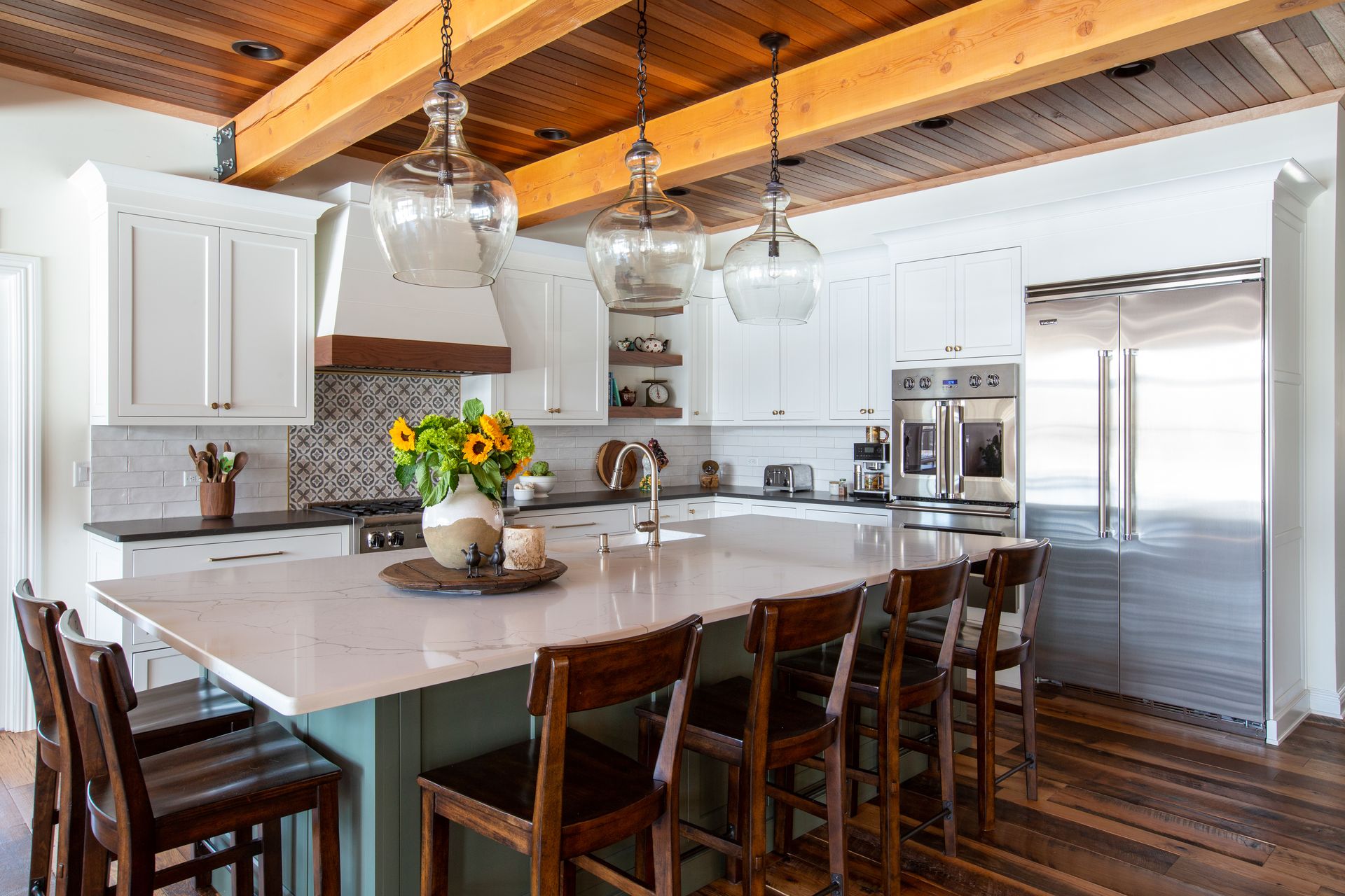 Spacious kitchen remodeling with large island, white cabinetry, wood beam ceiling, modern lighting, and stainless-steel appliances – Kitchen Remodeling NJ